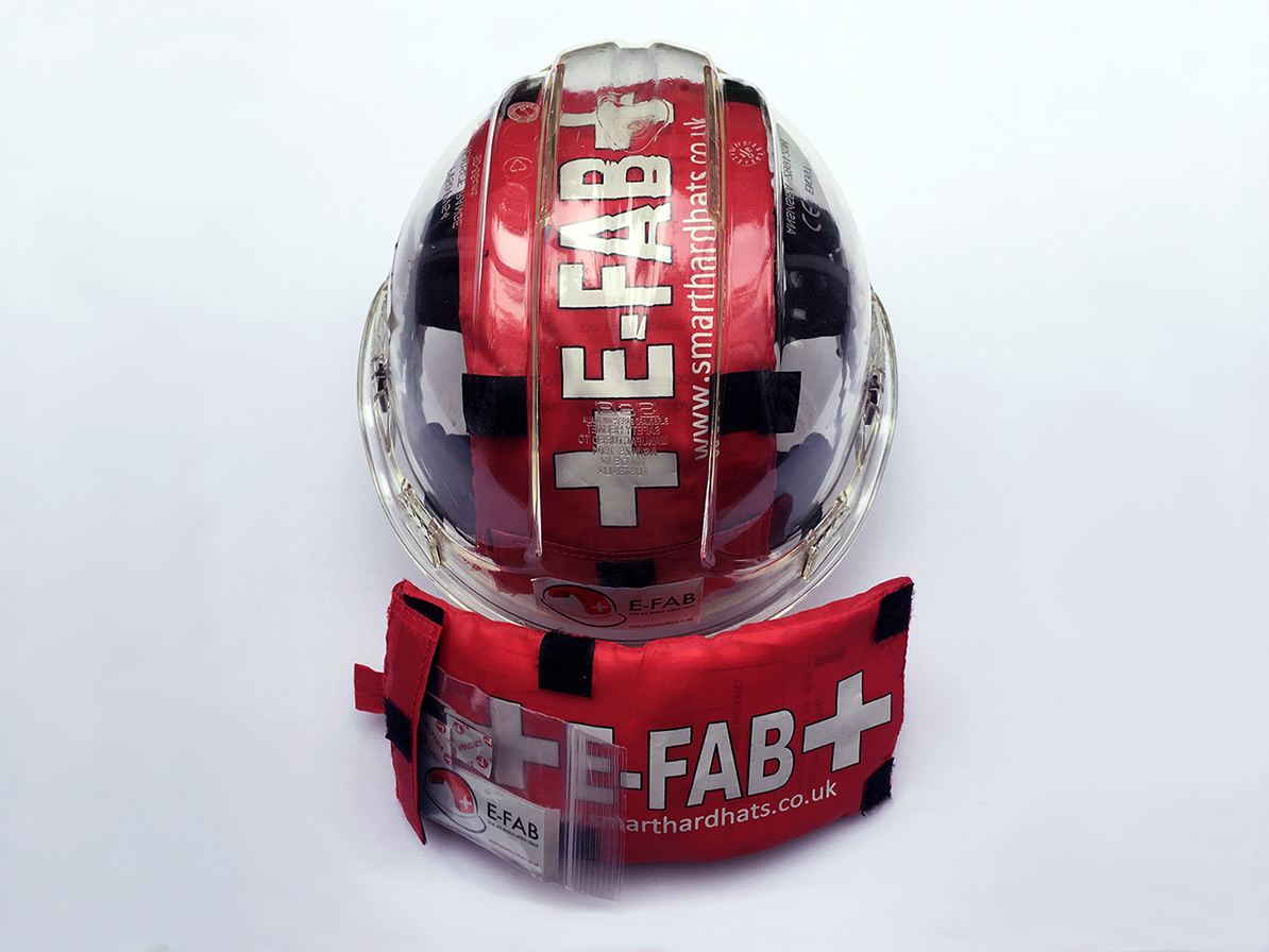 Photo of the E-FAB installed in a clear hard hat, beside an uninstalled E-FAB pack